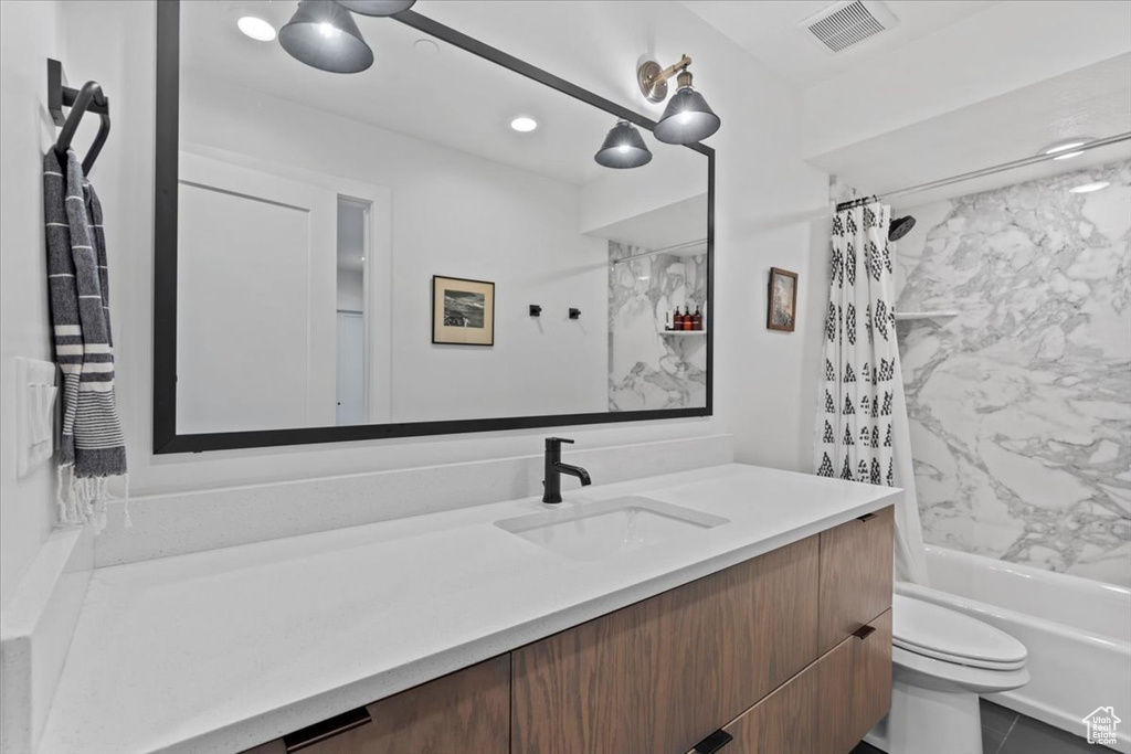 Full bath with vanity and shower / bath combination with curtain