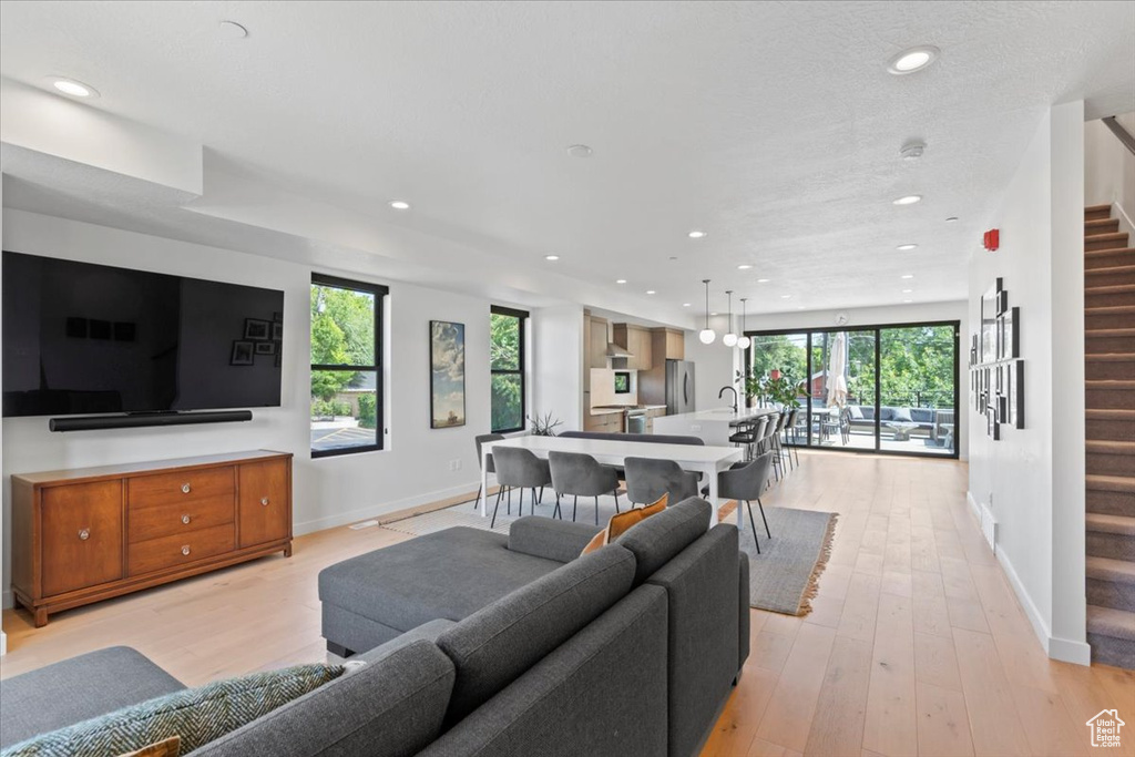 Living area featuring stairway, recessed lighting, and light wood finished floors