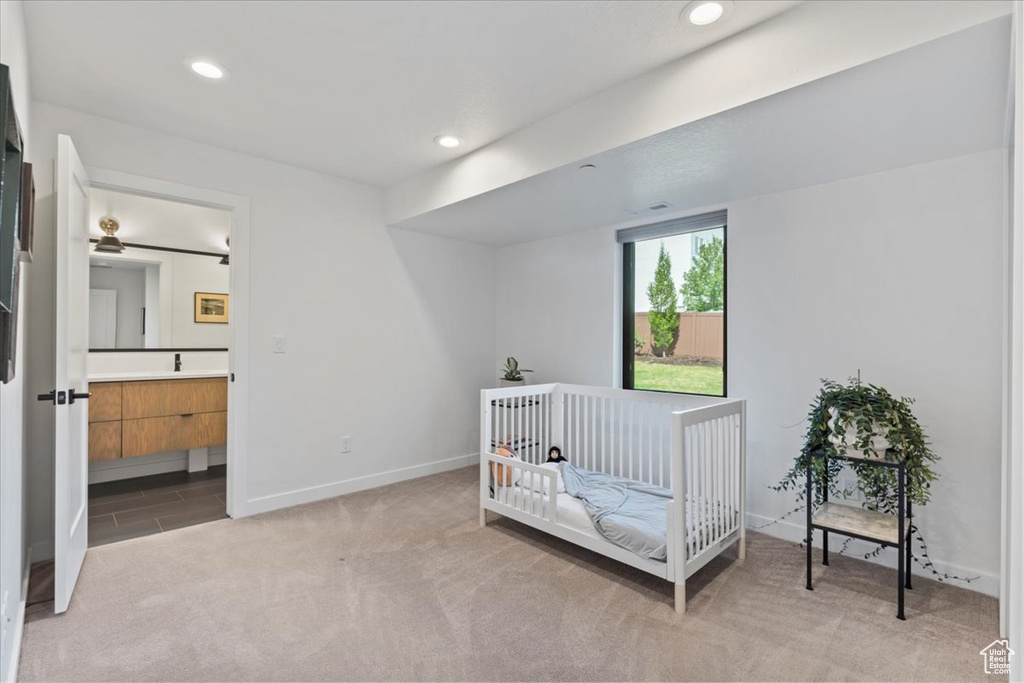 Bedroom with light carpet, recessed lighting, and ensuite bathroom