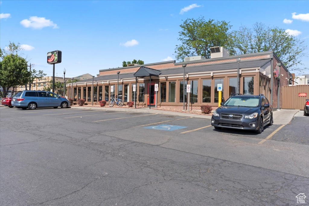 View of building exterior with uncovered parking