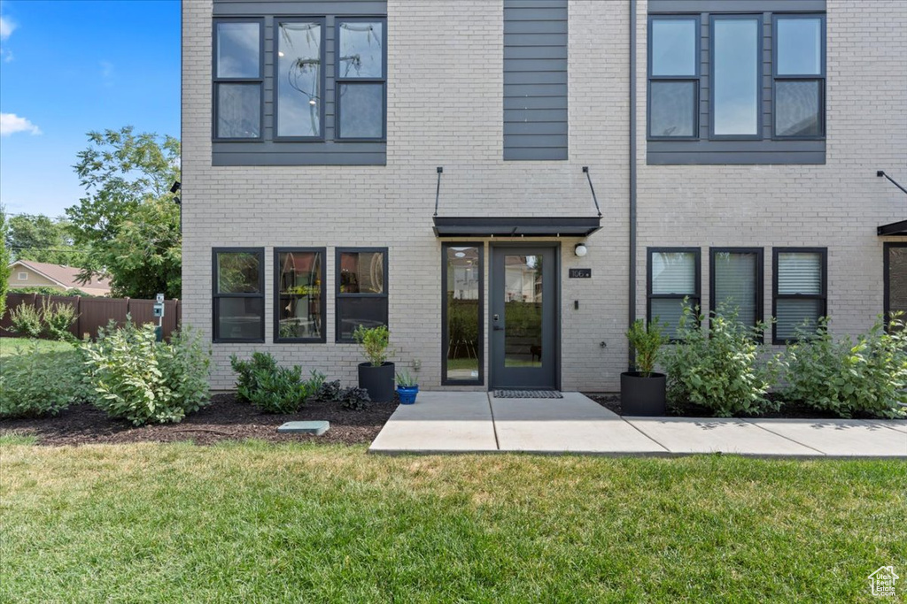 Rear view of house featuring brick siding