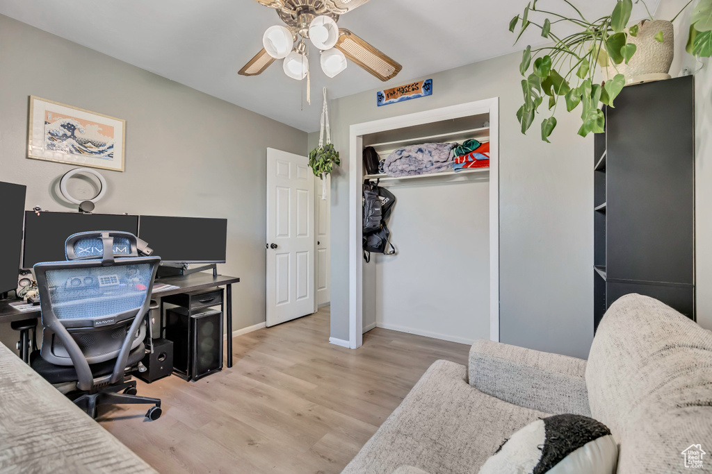 Home office featuring a ceiling fan and wood finished floors