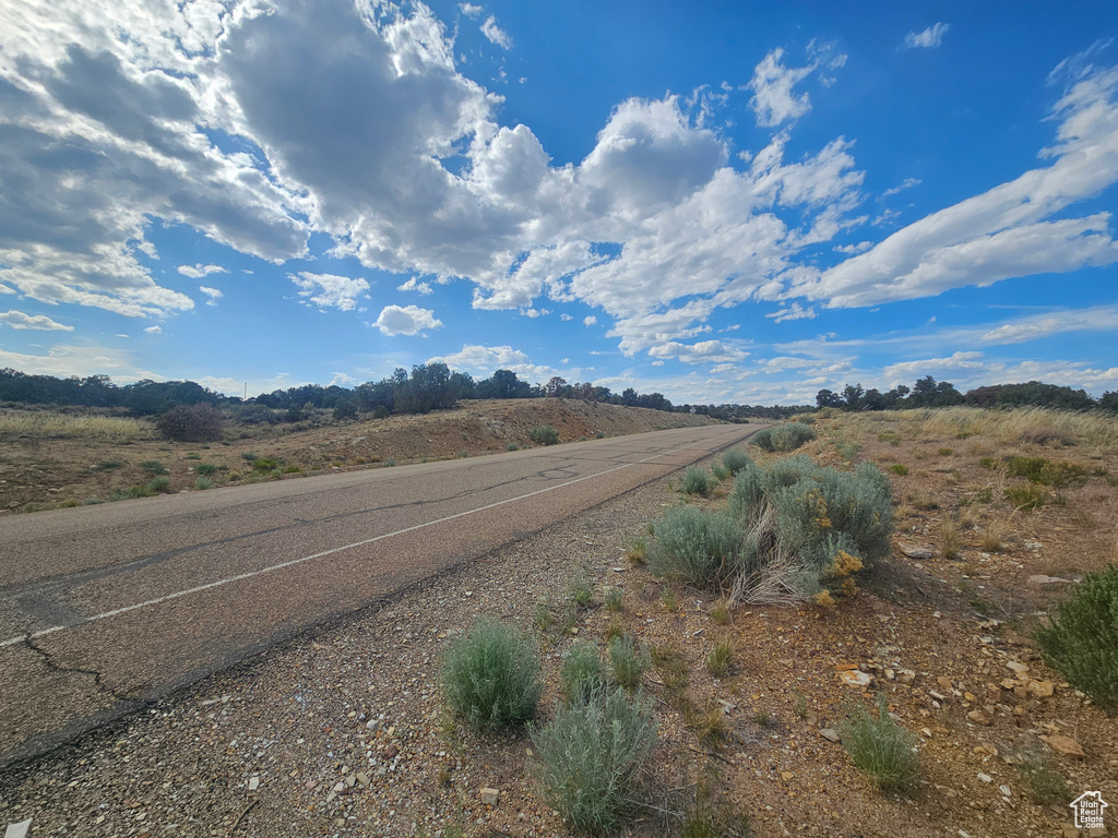 View of asphalt road with a view of rural / pastoral area
