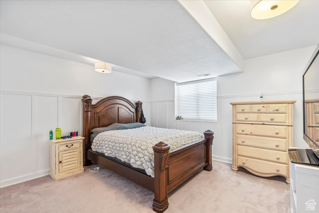 Bedroom featuring light carpet