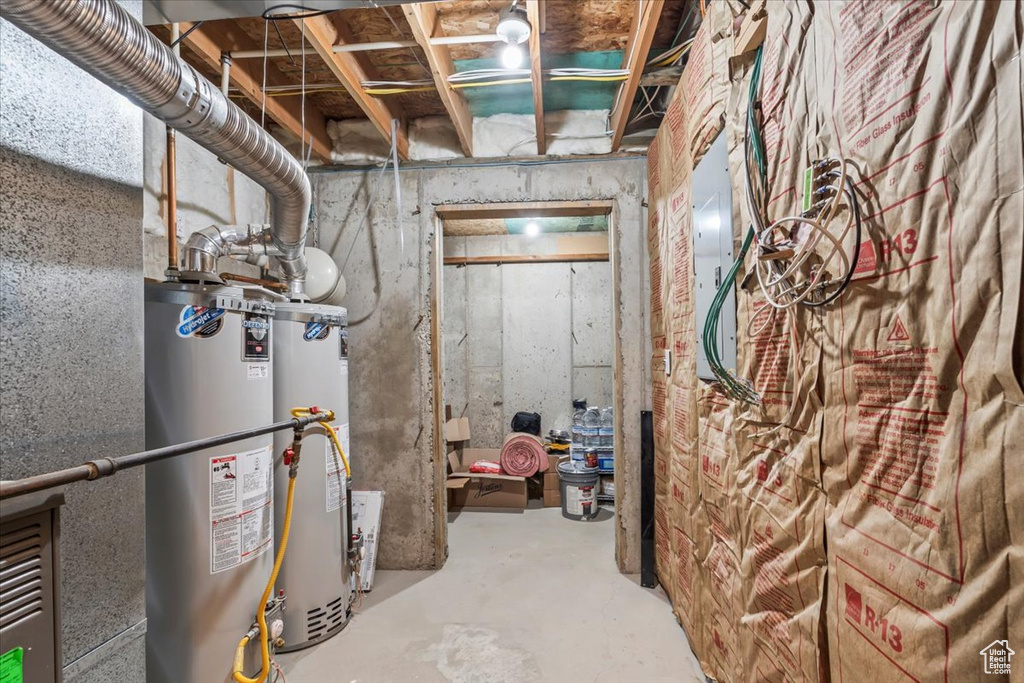 Unfinished below grade area featuring water heater
