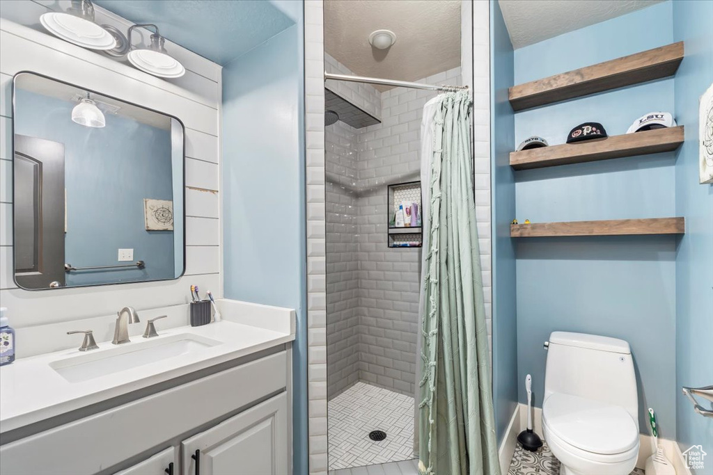 Bathroom featuring vanity, a stall shower, and tile patterned flooring