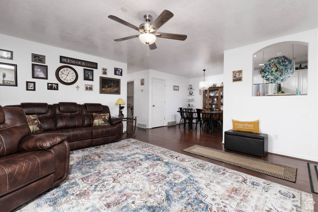 Living room featuring ceiling fan and wood finished floors