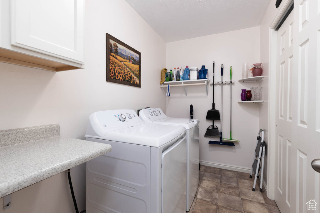 Laundry room with cabinet space and washer and dryer