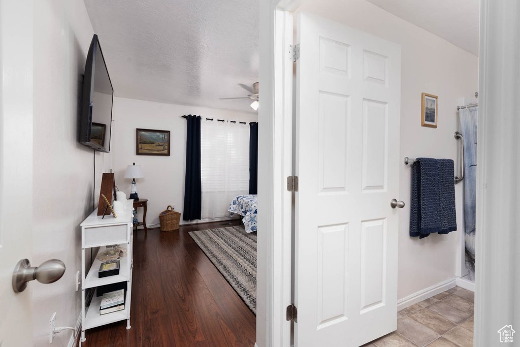 Hallway with baseboards and wood finished floors