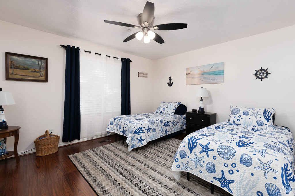 Bedroom with wood finished floors and a ceiling fan