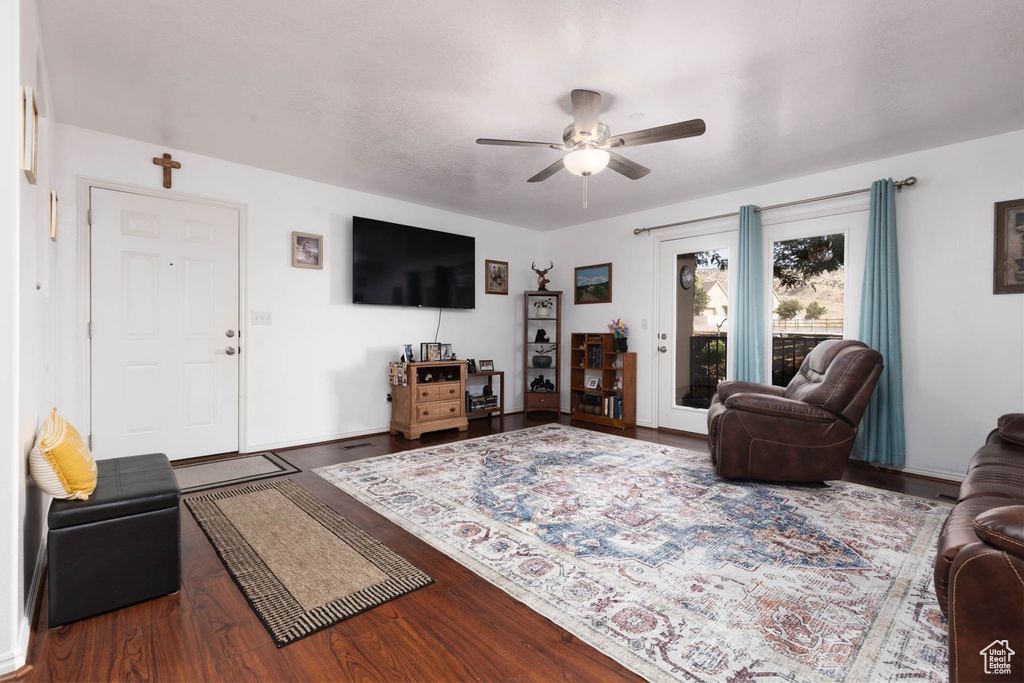 Living room with a ceiling fan and wood finished floors