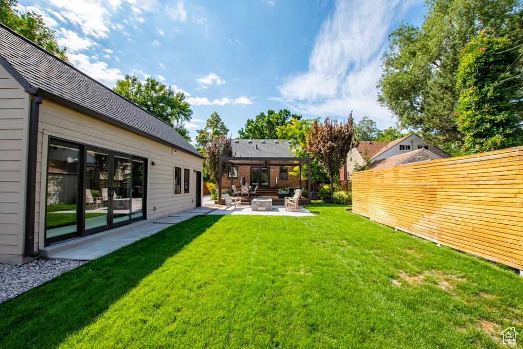 Fenced yard featuring a patio and an outdoor hangout area