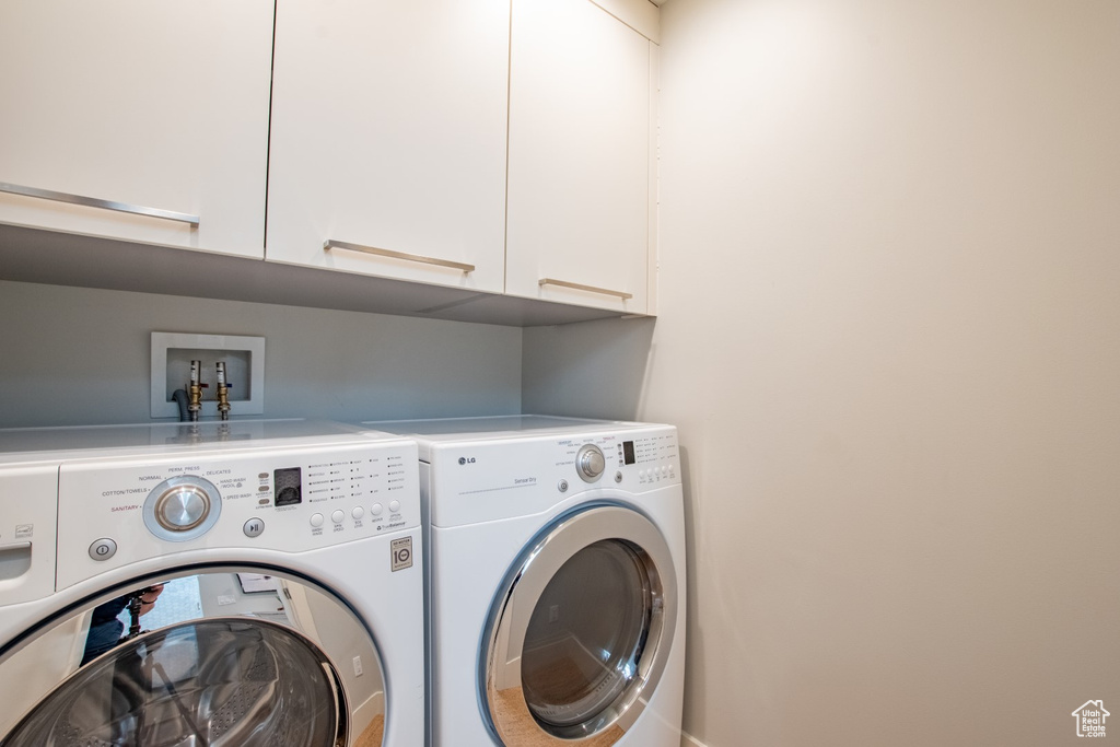 Laundry area with washer and dryer and cabinet space