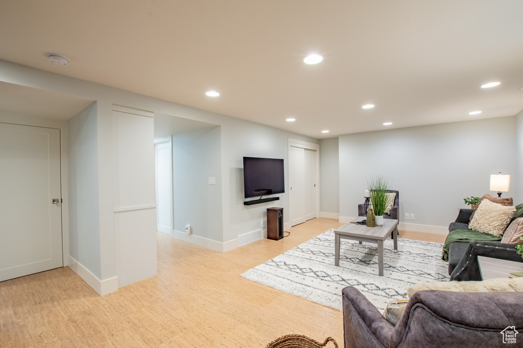 Living room with recessed lighting and light wood finished floors