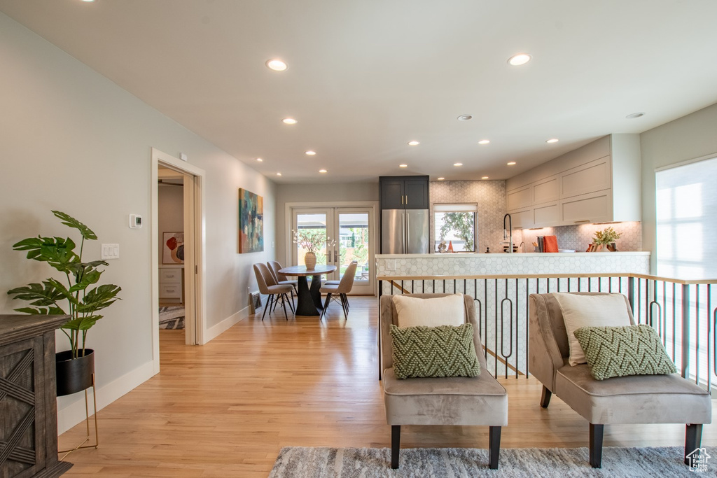 Living area with light wood-style floors and recessed lighting