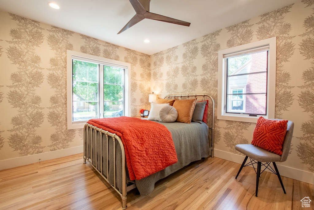 Bedroom with multiple windows, light wood finished floors, recessed lighting, and ceiling fan