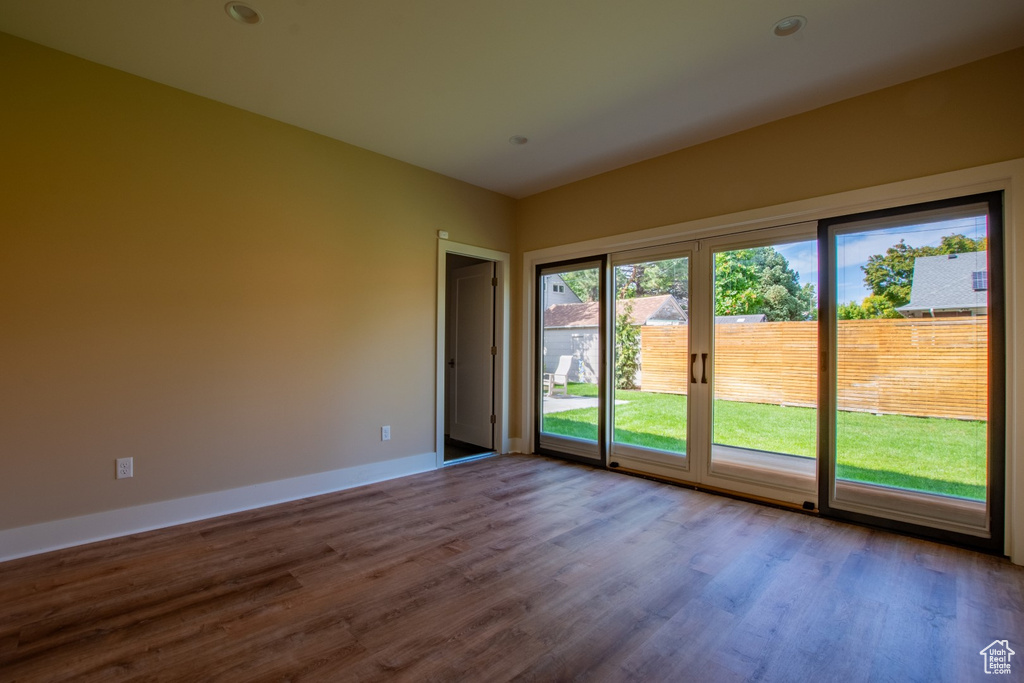 Unfurnished room with wood finished floors and baseboards