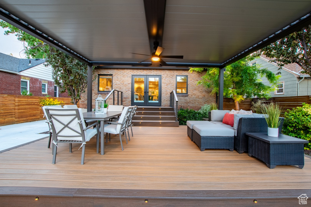 Wooden deck with french doors, outdoor dining area, and an outdoor hangout area