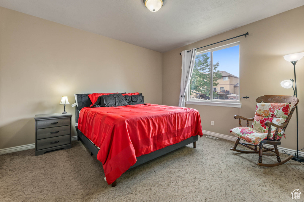 Carpeted bedroom featuring baseboards