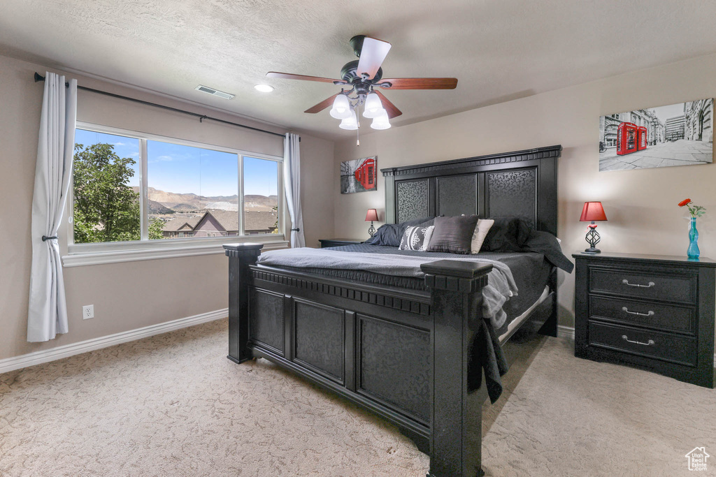 Bedroom with light carpet and ceiling fan