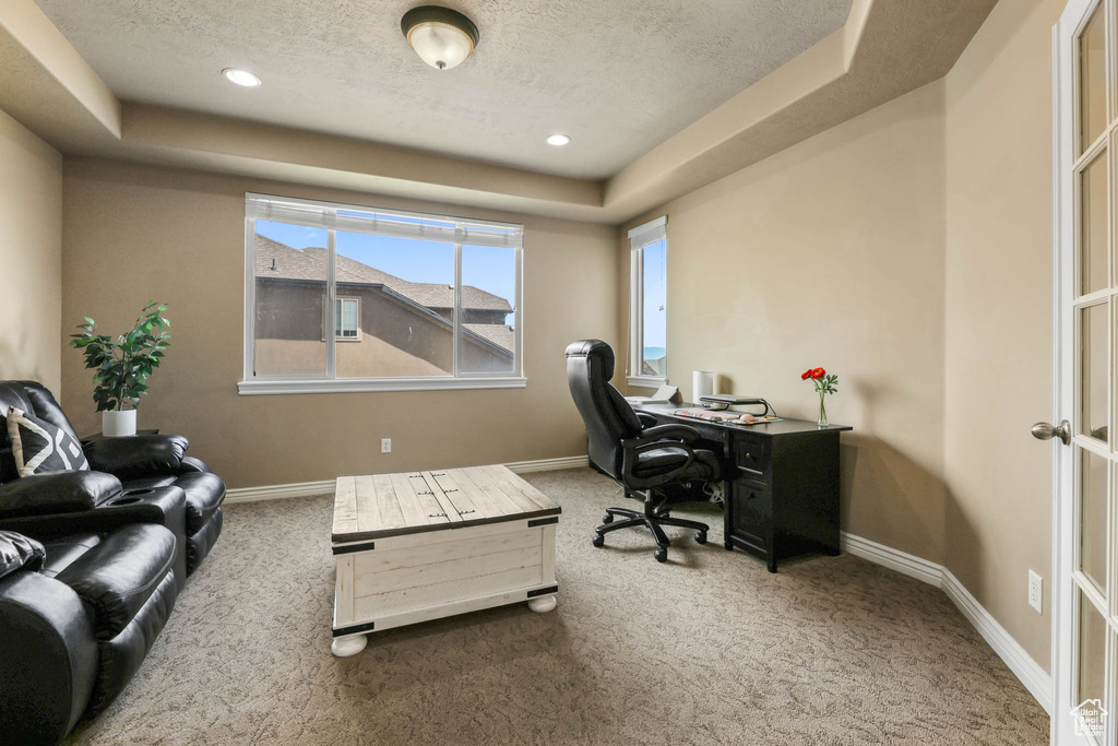 Home office with a tray ceiling, carpet flooring, a textured ceiling, and recessed lighting