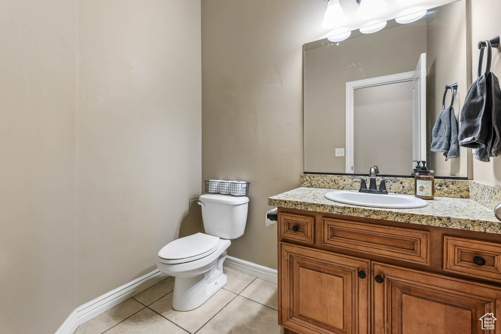 Half bath featuring tile patterned floors and vanity