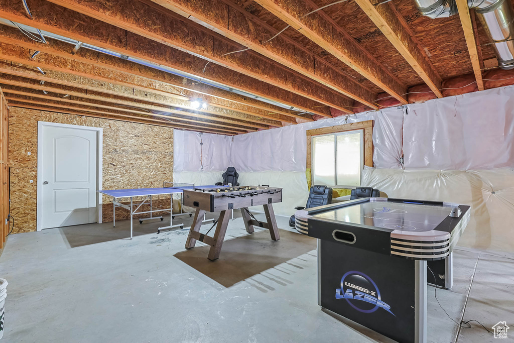 Game room with unfinished concrete floors