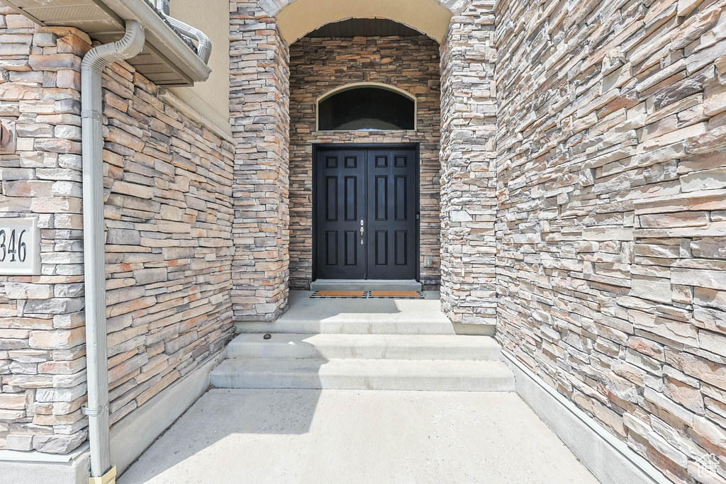 Entrance to property with stone siding
