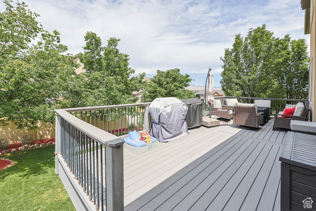 Deck featuring an outdoor hangout area and a lawn