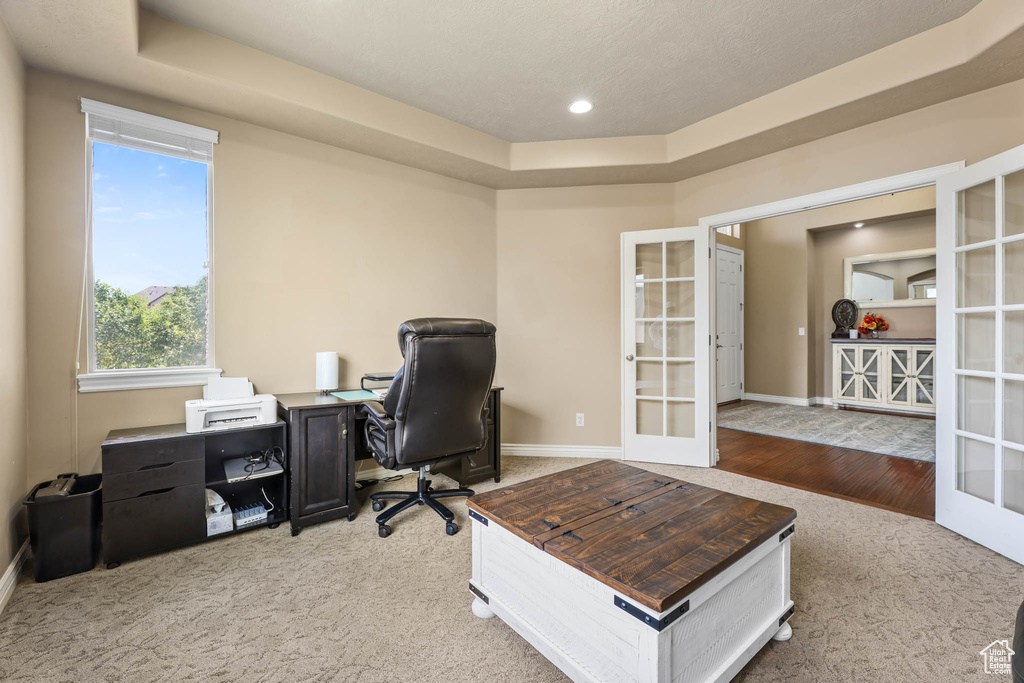 Office with french doors, carpet floors, a tray ceiling, and recessed lighting