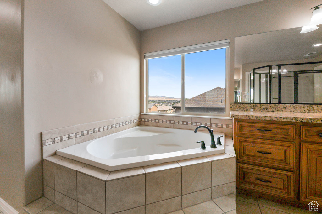 Bathroom featuring vanity, a garden tub, tile patterned flooring, a stall shower, and recessed lighting