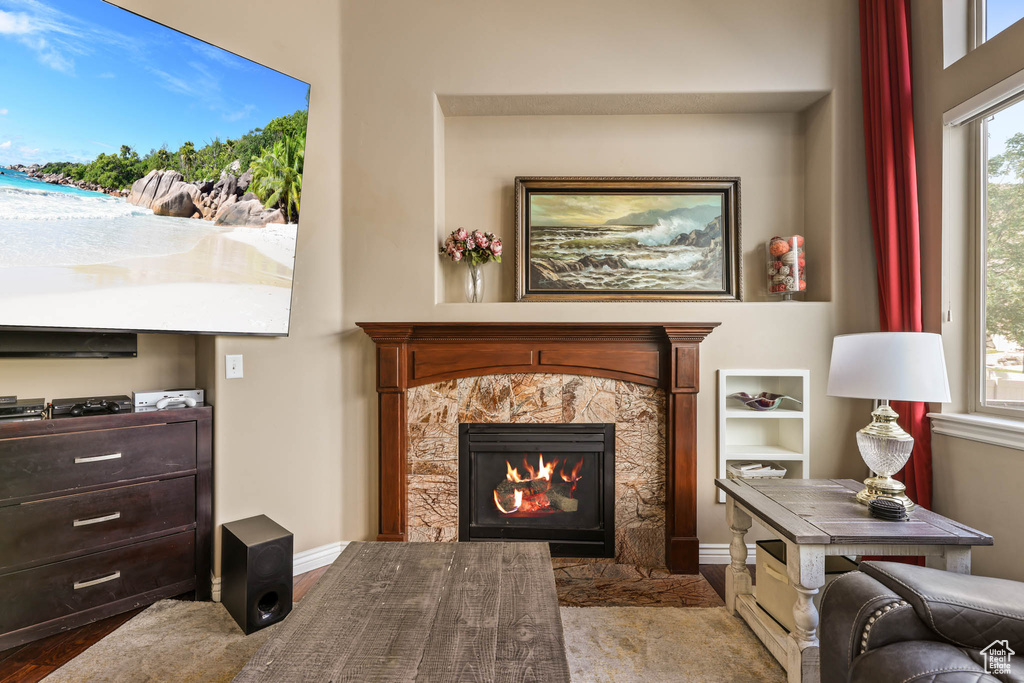 Sitting room featuring wood finished floors and a fireplace with flush hearth