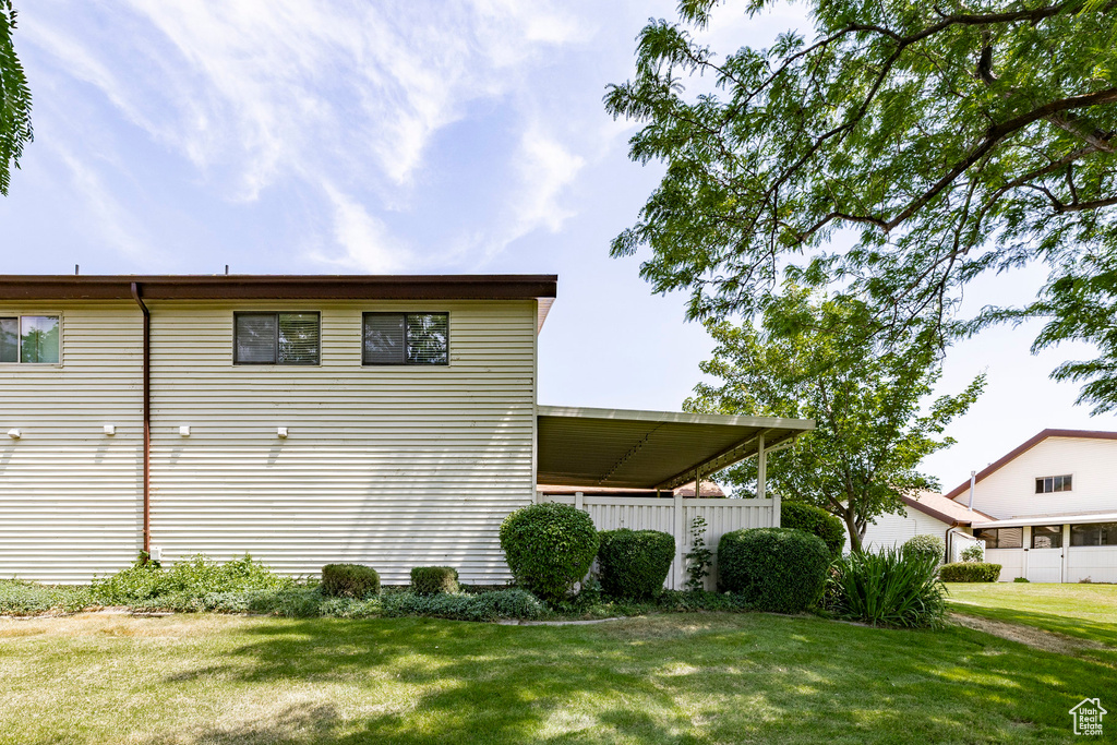 View of side of property with a lawn