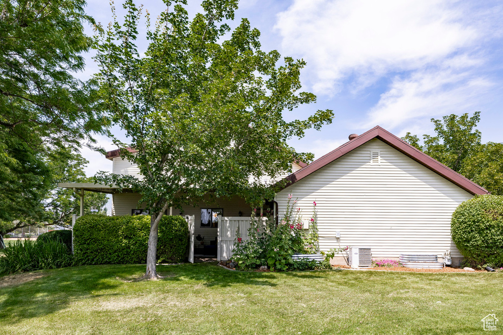 View of side of property featuring a yard