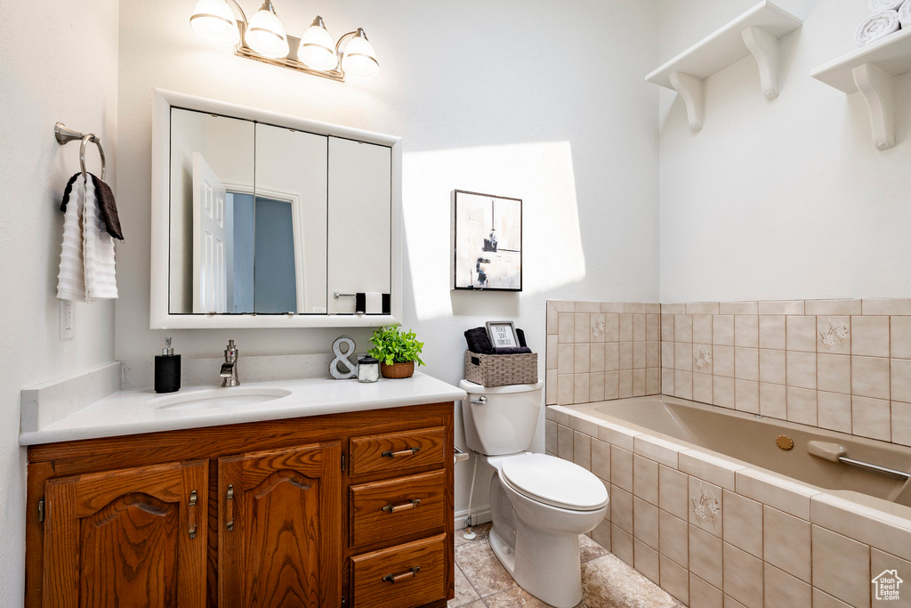 Bathroom with a garden tub, vanity, and tile patterned floors