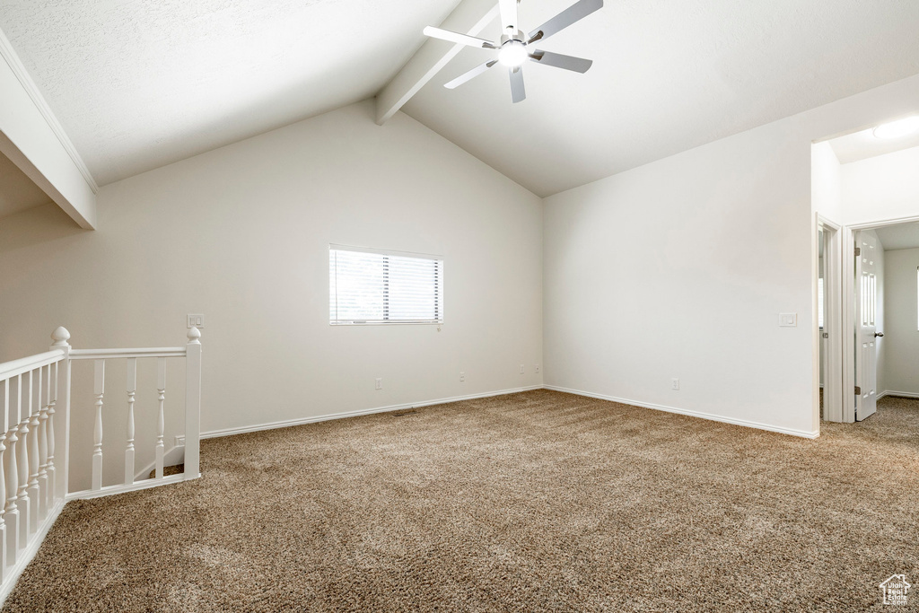 Carpeted spare room featuring ceiling fan and baseboards