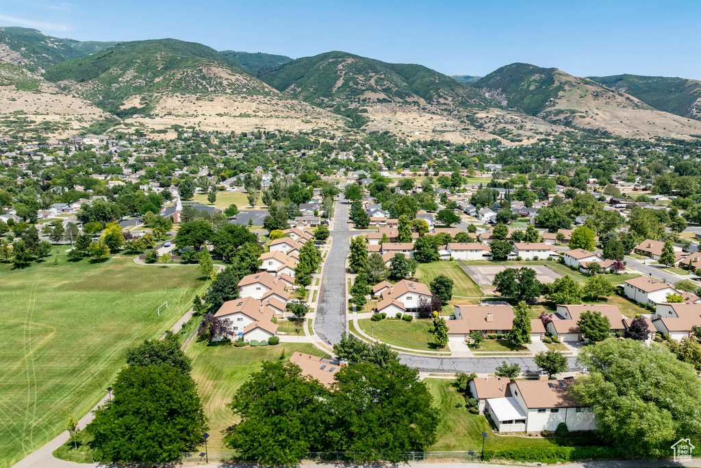 Aerial view of residential area featuring a mountainous background