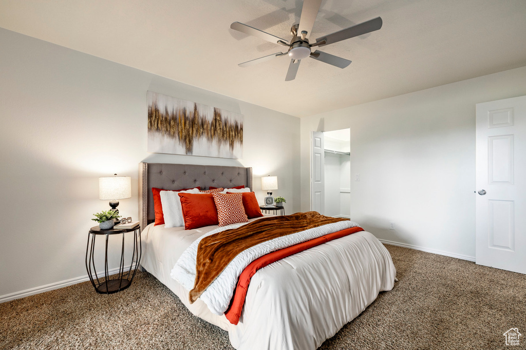 Carpeted bedroom with baseboards and a ceiling fan