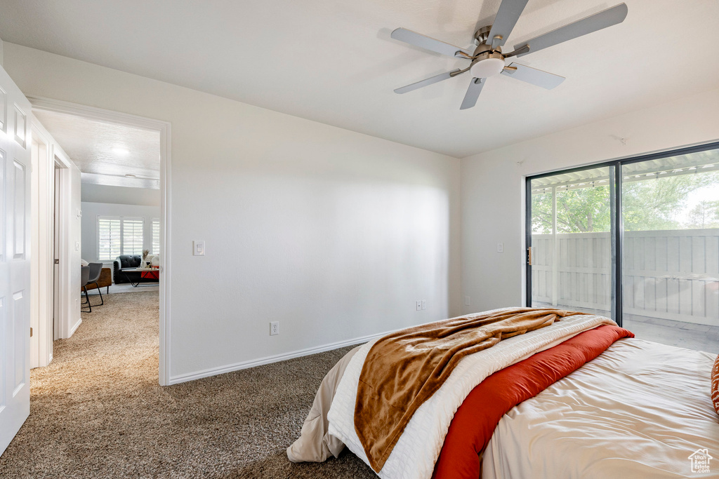 Bedroom featuring access to outside, carpet, and ceiling fan