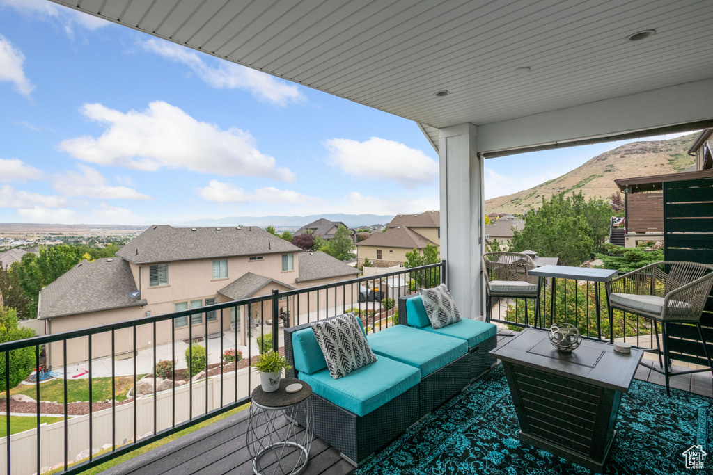 Wooden terrace featuring a residential view and a mountain view