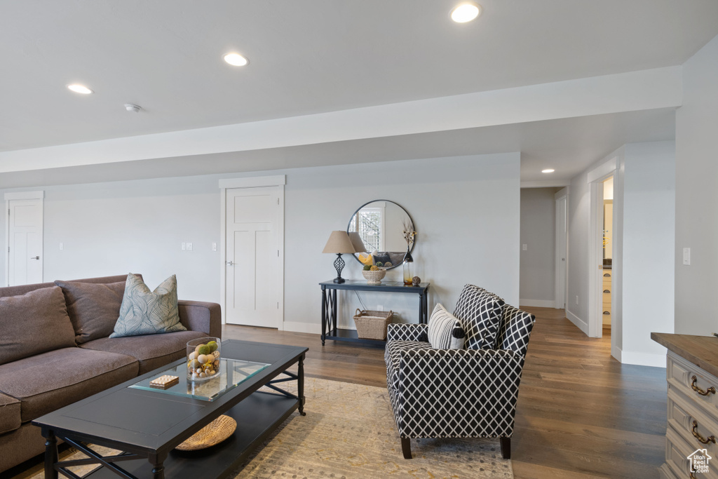 Living room featuring dark wood-style flooring and recessed lighting