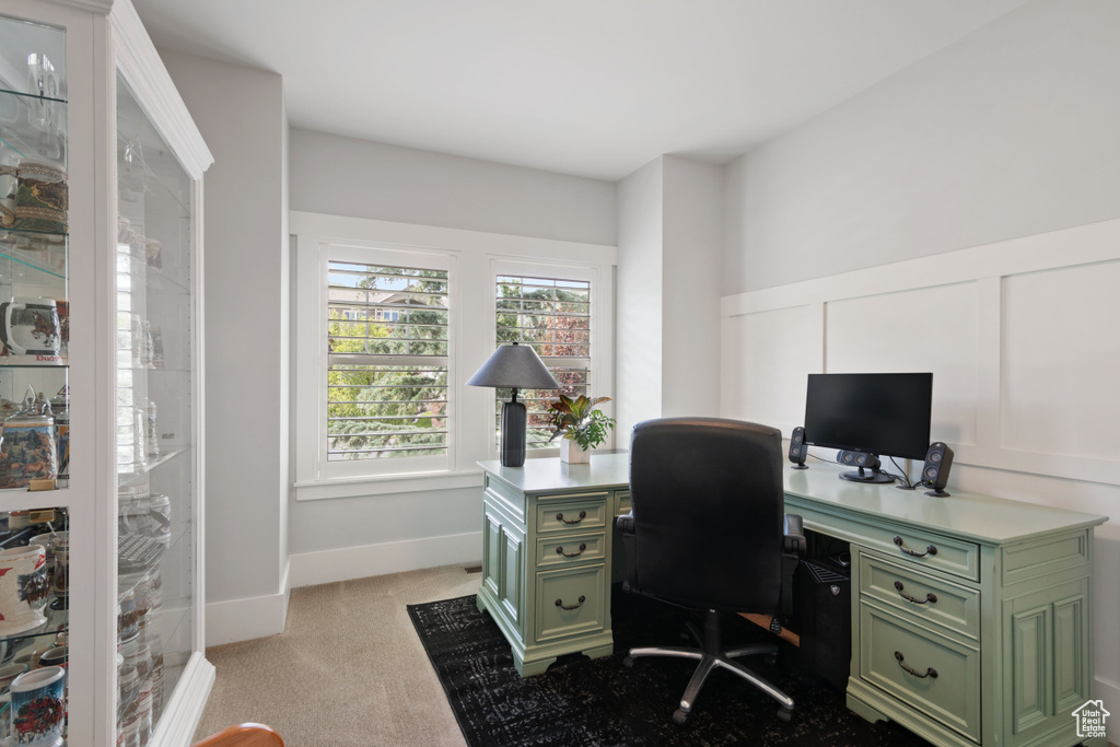 Home office with light carpet and baseboards