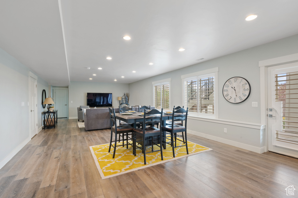 Dining space with light wood-type flooring and recessed lighting