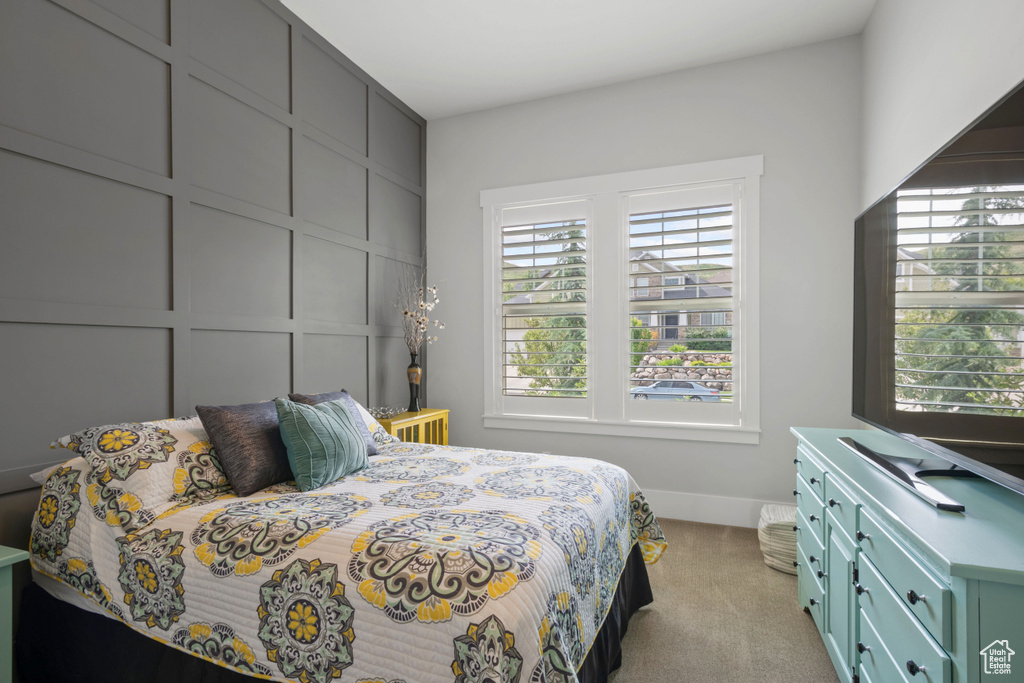 Bedroom with carpet flooring and baseboards