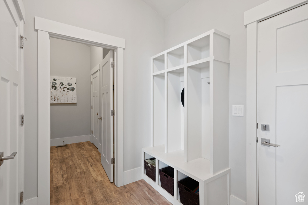 Mudroom featuring light wood-type flooring and baseboards