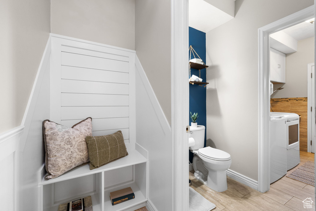 Bathroom featuring wood finished floors and a wainscoted wall