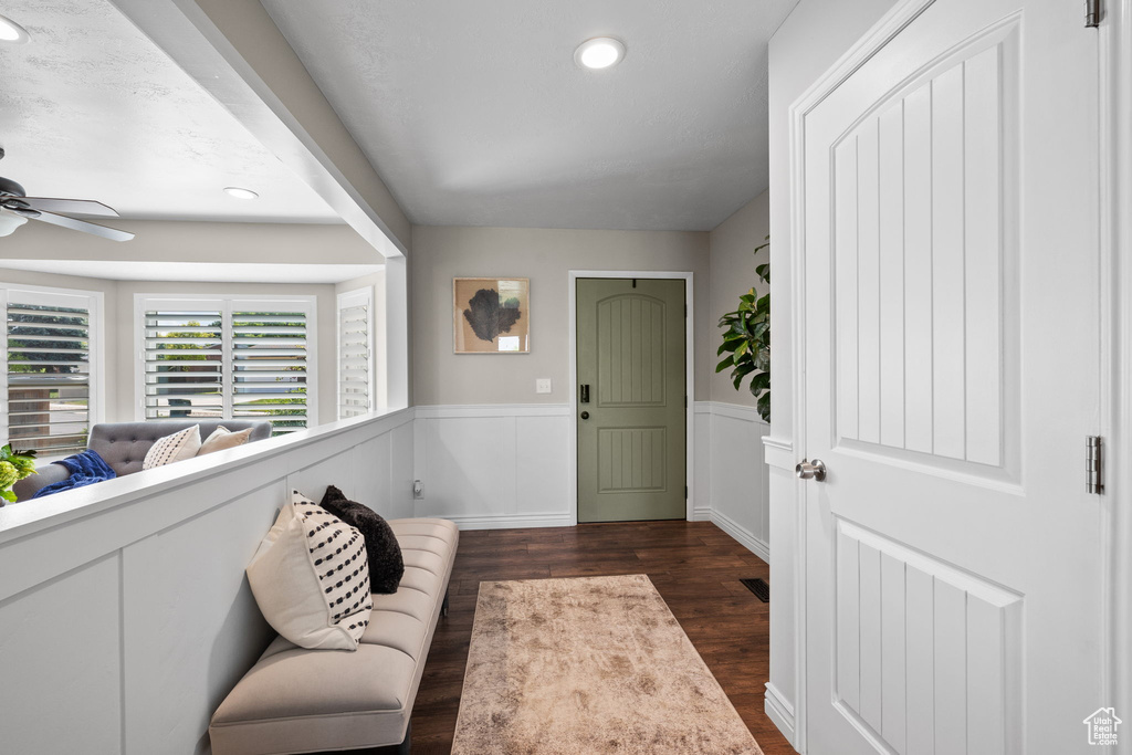 Foyer featuring dark wood-style floors, ceiling fan, recessed lighting, and a wainscoted wall
