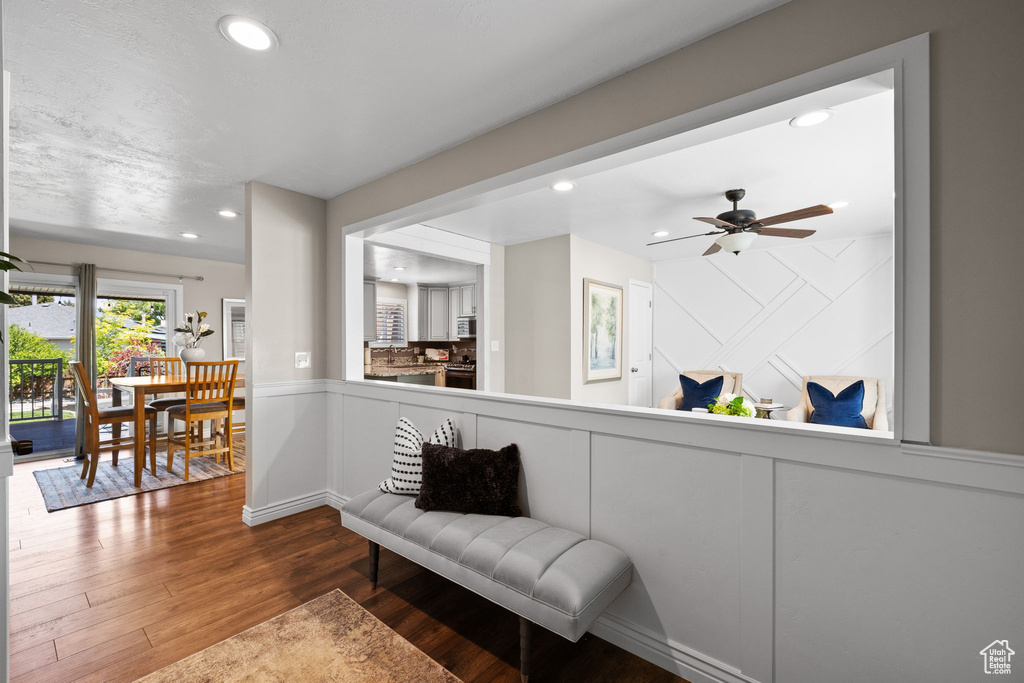 Sitting room featuring recessed lighting, wood finished floors, a ceiling fan, and a decorative wall