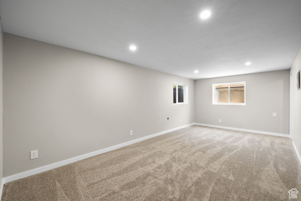 Spare room with recessed lighting and light carpet