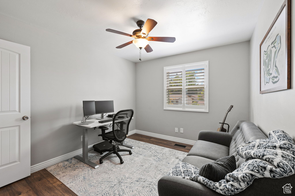 Home office with dark wood finished floors and ceiling fan